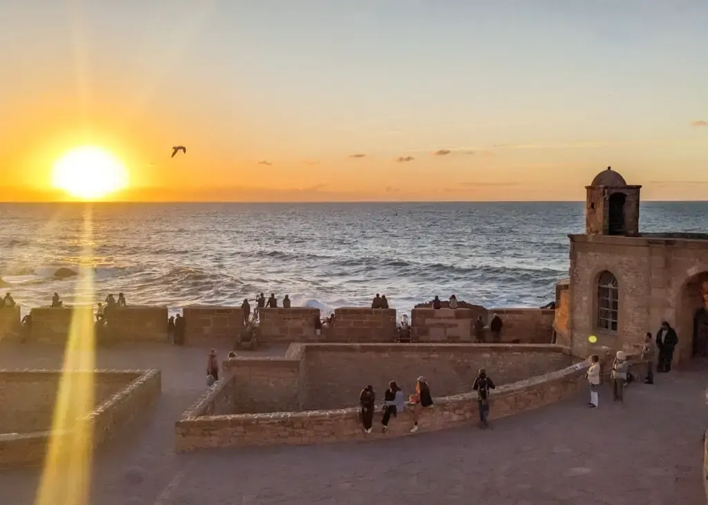 Historic cannons along Skala de la Ville ramparts at sunset overlooking Atlantic Ocean